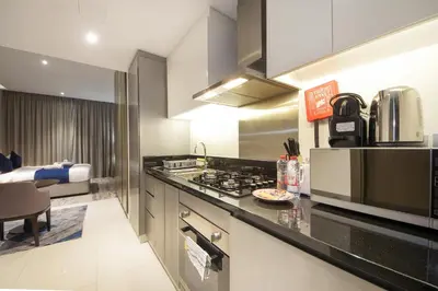 a kitchen with a stove and a counter top at Stylish Damac Prive Studio on hghFlr with Canal View in Dubai