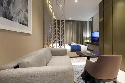 a living room with a couch and a bed at Stylish Damac Prive Studio on hghFlr with Canal View in Dubai