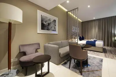 a hotel room with a bedroom and a bed at Stylish Damac Prive Studio on hghFlr with Canal View in Dubai