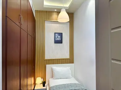 a bedroom with a bed and a painting on the wall at Retreat One Room In Tecom Barsha Heights in Dubai