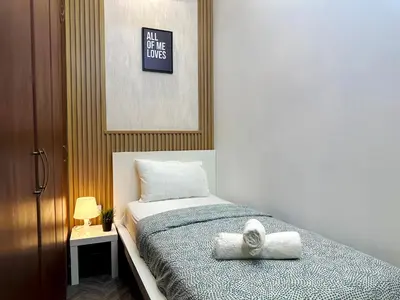 a bedroom with a bed with two towels on it at Retreat One Room In Tecom Barsha Heights in Dubai