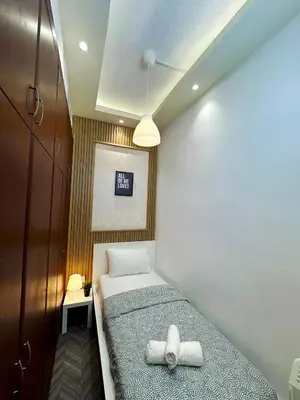 a small bedroom with a bed with towels on it at Retreat One Room In Tecom Barsha Heights in Dubai