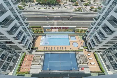 an overhead view of a building with a swimming pool at StayShort - Beautiful Al Furjan 2 bed apartment for 4 people in Dubai