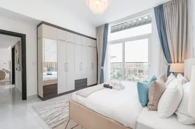 a bedroom with a large bed and a large window at StayShort - Beautiful Al Furjan 2 bed apartment for 4 people in Dubai