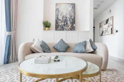 a living room with a couch and a table at StayShort - Beautiful Al Furjan 2 bed apartment for 4 people in Dubai