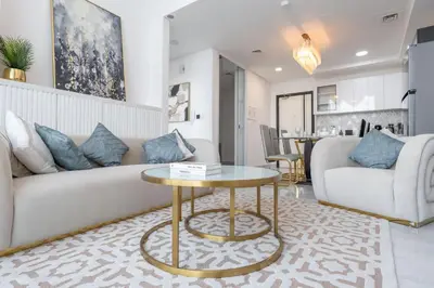 a living room with a couch and a table at StayShort - Beautiful Al Furjan 2 bed apartment for 4 people in Dubai