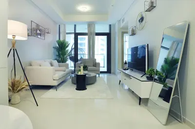 a living room with a couch and a tv at 2BR I Aykon City I Business Bay I Bshh in Dubai