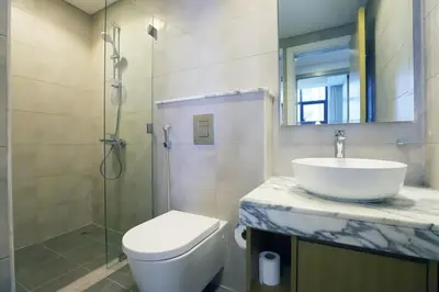 a bathroom with a sink and a toilet and a shower at 2BR I Aykon City I Business Bay I Bshh in Dubai