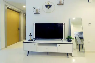 a living room with a large television on a white cabinet at 2BR I Aykon City I Business Bay I Bshh in Dubai
