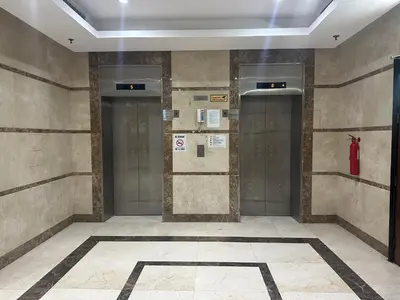 a hallway with two elevators in a building at Lotel Al Barsha 1 at the Mall in Dubai