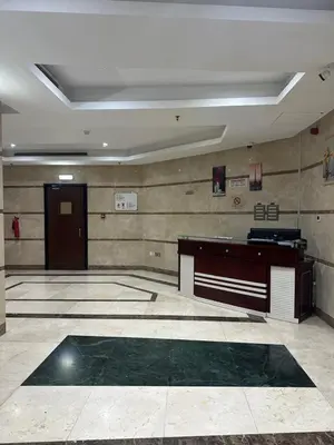 a large room with a desk and a door at Lotel Al Barsha 1 at the Mall in Dubai