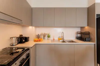 a kitchen with a sink and a counter top at Grande Signature Residence by Hogar in Dubai