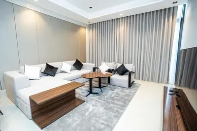 a living room with a couch and a table at High-Rise Comfort 2BR in Nobles Tower in Dubai in Dubai