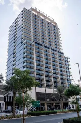 a tall building with a sign in front of it at Luxe Studio Retreat Jacuzzi Parking, Pool & Gym in Dubai