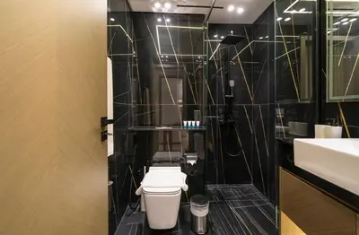a bathroom with a toilet and a sink at Stylish 1BR Apartment in Binghatti Luna JVC Dubai in Dubai