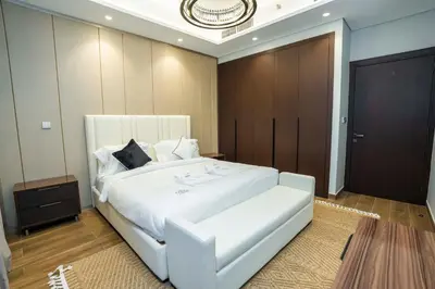 a bedroom with a large white bed in a room at Modern 2BR Apartment Nobles Tower Dubai Views in Dubai