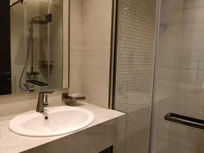 a bathroom with a sink and a shower at Modern 2BR Apartment Nobles Tower Dubai Views in Dubai