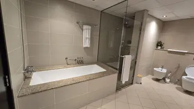 a bathroom with a sink and a shower and a toilet at Stunning 1BR at Anantara Sea Views Palm Jumeirah in Dubai