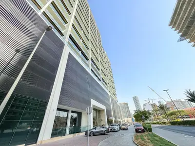 a large building with cars parked in front of it at Luxury 1BR Apt Binghatti Amber Prime Location in Dubai