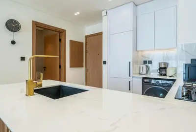 a kitchen with a white counter top with a sink at Stylish Comfort Modern 1BR Apt Prime Location JVC in Dubai