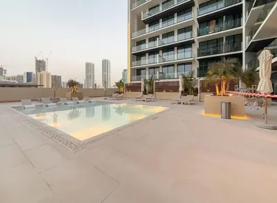a swimming pool on the roof of a building at Stylish Comfort Modern 1BR Apt Prime Location JVC in Dubai
