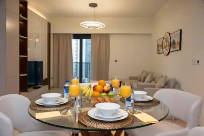 a dining room with a glass table with fruit on it at Elegant Style Brand new 2BDR in Heart of Downtown in Dubai