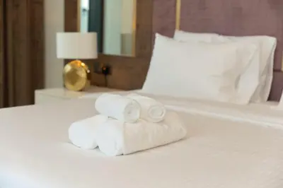 a pile of towels sitting on top of a bed at Elegant Style Brand new 2BDR in Heart of Downtown in Dubai