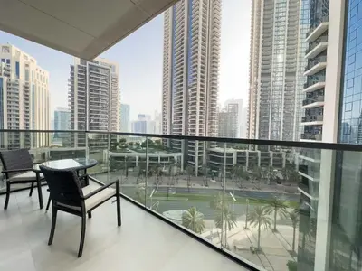 a balcony with a table and chairs and a view of a city at Elegant Style Brand new 2BDR in Heart of Downtown in Dubai