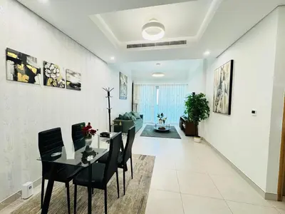 a dining room with a black table and chairs at Luxury 1BR The Bay Scenic Canal Creek Outlook in Dubai