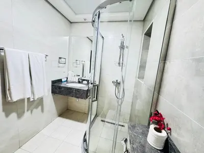 a bathroom with a shower and a sink at Luxury 1BR The Bay Scenic Canal Creek Outlook in Dubai