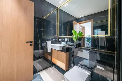a bathroom with a toilet and a sink and a mirror at Comfortable 1-Bedroom Getaway Binghatti House in Dubai