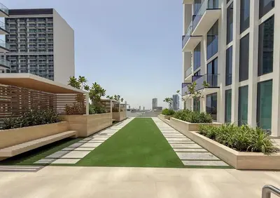 a green lawn in the middle of a building at Skyline Views from Binghatti House in Dubai