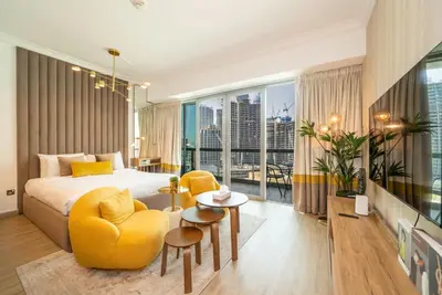a hotel room with a bed and a large window at Stylish Studio Steps from Burj Khalifa Fountains in Dubai