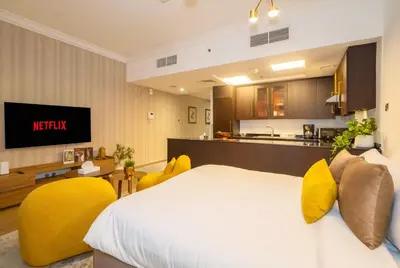 a hotel room with a bed and a kitchen at Stylish Studio Steps from Burj Khalifa Fountains in Dubai
