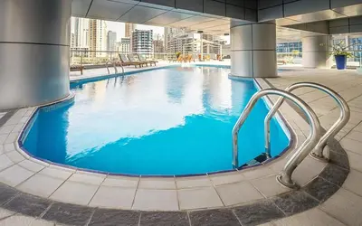 a large pool with blue water in a building at Keyrock - Dubai Marina Apartment with Stunning Sea View, Pool, Gym & Free Parking in Dubai