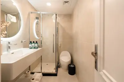 a bathroom with a shower and a sink and a toilet at Keyrock - Dubai Marina Apartment with Stunning Sea View, Pool, Gym & Free Parking in Dubai