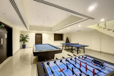 a room with a pool table and ping pong balls at Keyrock - Dubai Marina Apartment with Stunning Sea View, Pool, Gym & Free Parking in Dubai