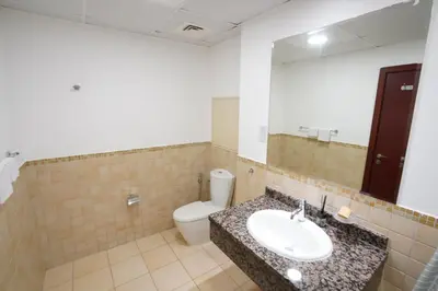a bathroom with a sink and a toilet and a mirror at Spacious 2 Bedroom in JBR with beach access in Dubai