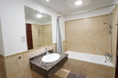 a bathroom with a sink and a bath tub at Spacious 2 Bedroom in JBR with beach access in Dubai
