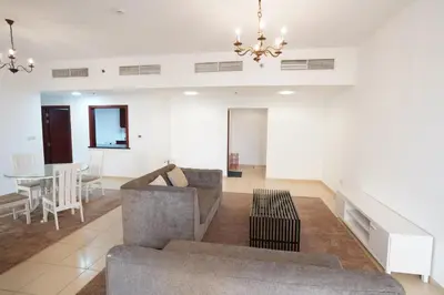 a living room with a couch and a table at Spacious 2 Bedroom in JBR with beach access in Dubai