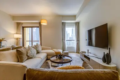a living room with couches and a flat screen tv at Rimal 1 in JBR - 1 Bedroom Apartment - Allsopp & Allsopp in Dubai