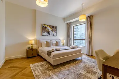 a bedroom with a bed and a large window at Rimal 1 in JBR - 1 Bedroom Apartment - Allsopp & Allsopp in Dubai