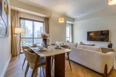 a living room with a table and a couch at Rimal 1 in JBR - 1 Bedroom Apartment - Allsopp & Allsopp in Dubai