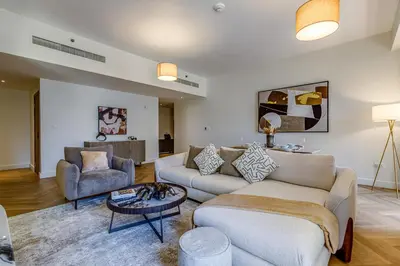 a living room with a couch and a table at Rimal 1 in JBR - 1 Bedroom Apartment - Allsopp & Allsopp in Dubai