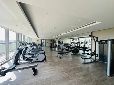 a gym with a bunch of treadmills and machines at Cozy 1br in Sobha Creek Vistas Creek Sea View in Dubai