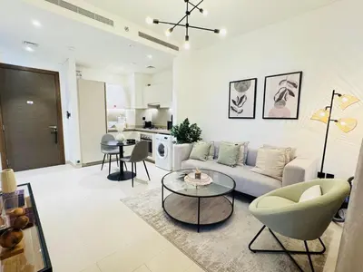 a living room with a couch and a table at Cozy 1br in Sobha Creek Vistas Creek Sea View in Dubai