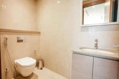 a bathroom with a toilet and a sink at SOBHA Hartland Grande 1 BHK in Dubai