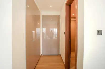 a hallway with a glass door in a building at SOBHA Hartland Grande 1 BHK in Dubai
