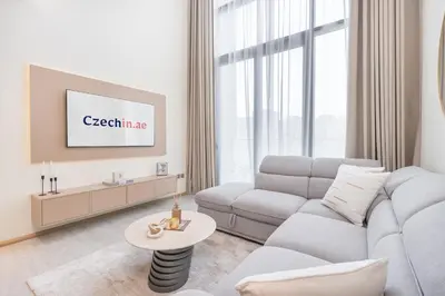 a living room with a couch and a table at Chic Duplex 1BHK by CzechIn Luxe Stay with Pool Gym in Dubai
