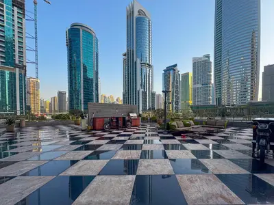 a checkered floor in a city with tall buildings at MBL Lake VIEW 1 BR in Dubai